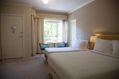 Postel nebo postele na pokoji v ubytování Oxley Motel