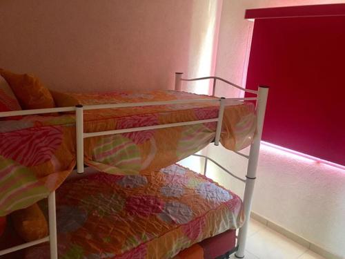 two bunk beds in a room with a window at marina diamante iris in Acapulco