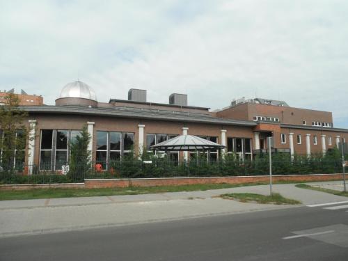a building with an umbrella in front of it at Galerius Apartment in Siófok
