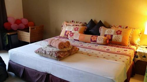 a large bed with pillows on top of it at Marose Gold Coast Morib in Morib