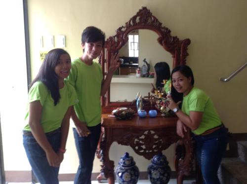 a group of people standing in front of a mirror at Danel Pensionne House in Tacloban