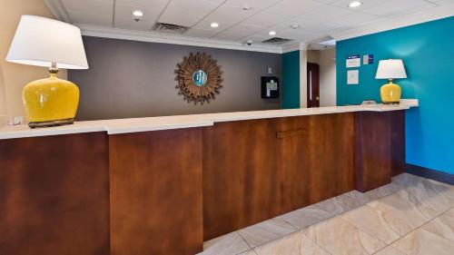 a reception desk in a hospital lobby with a lamp at Best Western Eagles Inn in Morehead