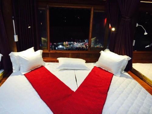 a red and white bed with a large window at Bac Ha Lake View in Bắc Hà