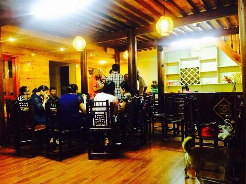 a group of people sitting at a table in a restaurant at Bac Ha Lake View in Bắc Hà