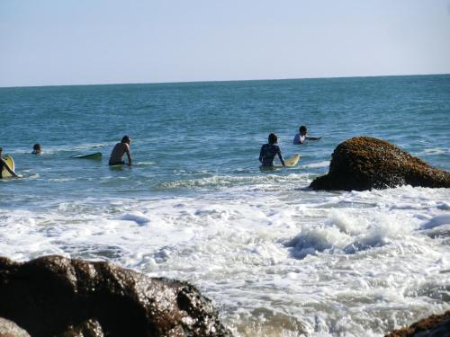 a group of people in the ocean with surfboards at The Tasty Tuna Cabana in Arugam Bay