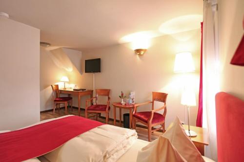 a hotel room with a bed and a table and chairs at Safestay Berlin Kurfurstendamm in Berlin