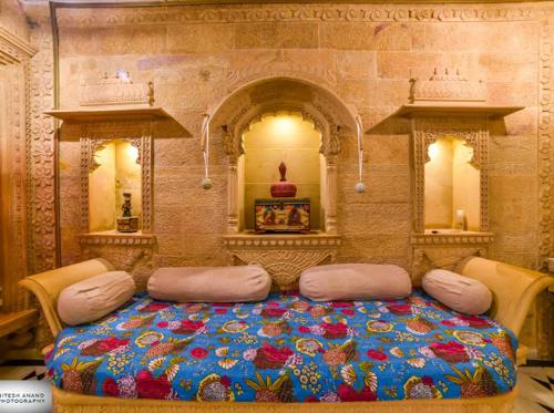 a bedroom with a large bed with flowers on it at Fort Villa in Jaisalmer