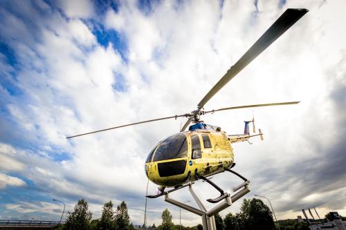 a yellow helicopter parked in a parking lot at Stadthotel Donauwörth in Donauwörth