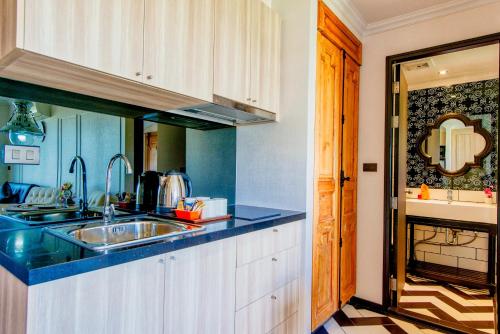 a kitchen with a sink and a blue counter top at Venetian Resort Pattaya in Jomtien Beach