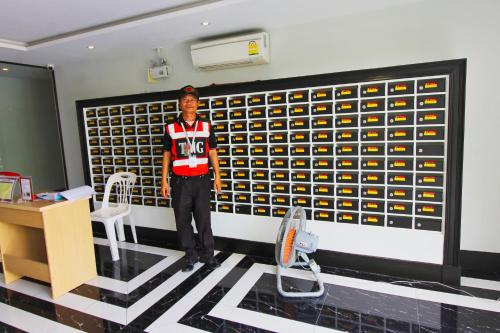 a man standing in a room with a wall of wine bottles at Venetian Resort Pattaya in Jomtien Beach