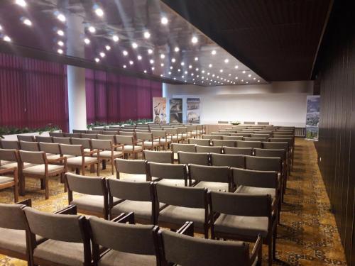 an empty lecture hall with chairs and a stage at Hotel Lovech in Lovech