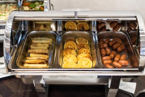 a tray of pastries and other foods in a buffet at Green Park Hotel & SPA in Truskavets