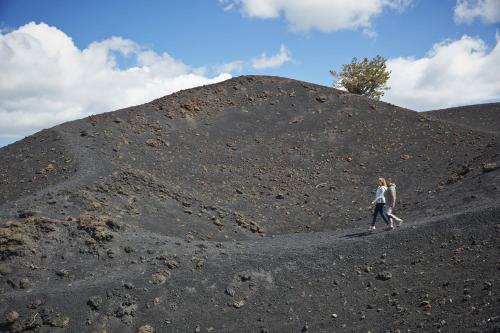a woman walking through a large mound of dirt at Grand Hotel Timeo, A Belmond Hotel, Taormina in Taormina