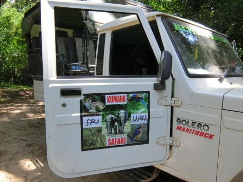 an open door of a white truck with posters on it at The Tasty Tuna Cabana in Arugam Bay