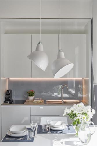 a kitchen with a table with plates and a sink at Matteotti Home Verona in Verona