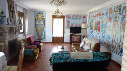 a living room with a couch and a fireplace at Casa Rural Egipto Parque Puy Du Fou a 12 kilómetros in Guadamur