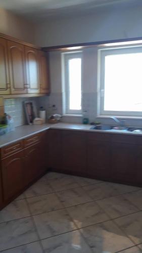 a kitchen with a sink and a window in it at Olympic View Guesthouse in Kalami