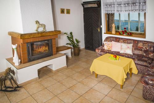 a living room with a fireplace and a couch at Wellness hotel Chata Jana in Lopeník