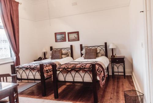 A bed or beds in a room at Bulawayo Club