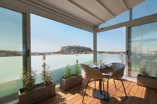a dining room with a view of the water at Athens Cypria Hotel in Athens