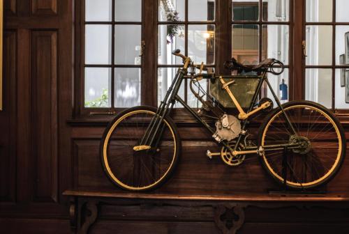 a bike parked on a table next to a window at Bulawayo Club in Bulawayo