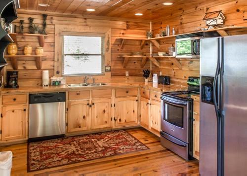 a kitchen with wooden cabinets and a stainless steel refrigerator at Scenic Serenity #75 in Sevierville