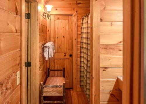 a tiny house hallway with a ladder and a bench at Scenic Serenity #75 in Sevierville