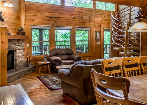 a living room with a couch and a fireplace at Hoot n Hollar #31 in Sevierville