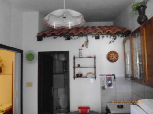 a kitchen with a white wall and a light at Apartments Lidija in Pag