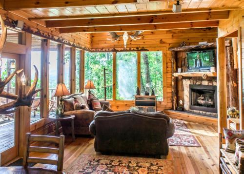 a living room with a couch and a fireplace at Scenic Serenity #75 in Sevierville