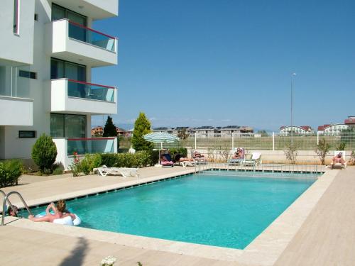 a swimming pool in front of a apartment building at Belek Golf Apartments in Belek