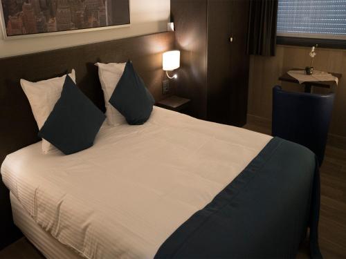 Postel nebo postele na pokoji v ubytování Hotel Orchidee