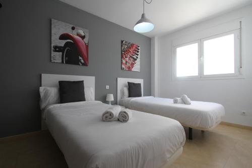 1 dormitorio con 2 camas y toallas. en For A Stay Las Arenas, en Cambrils