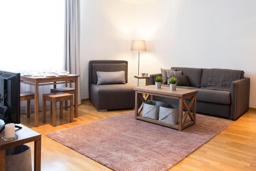 a living room with a couch and a table at Brzeće Center Apartments in Kopaonik