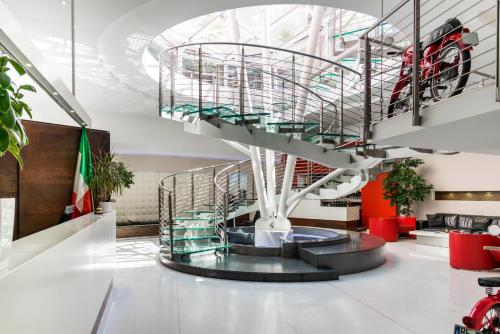 a spiral staircase in a building with a stair case at Ibis Styles Milano Centro in Milan