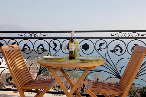 a table with a bottle of wine on a balcony at Apartments Oktopus in Sutomore