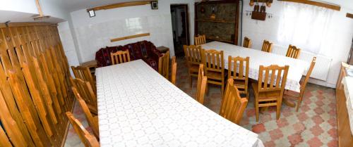 a dining room with tables and chairs in a church at Agro-pensiunea "Plaiul Castanilor" in Tismana
