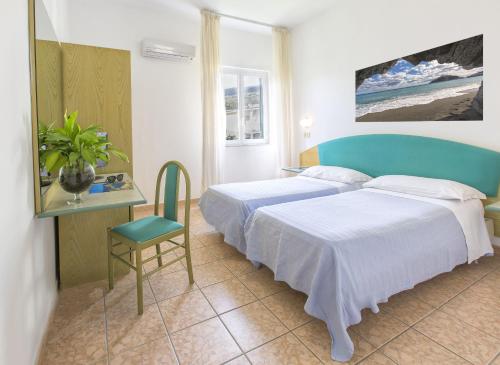 Postel nebo postele na pokoji v ubytování Hotel Vittoria