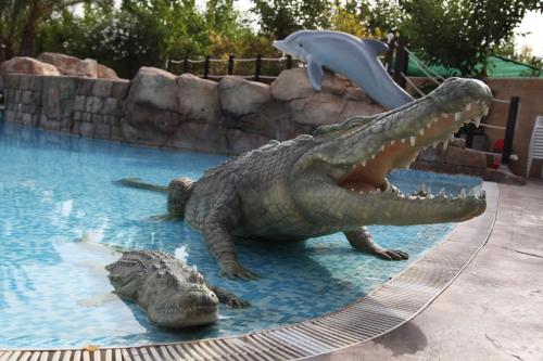 a fake crocodile and dolphin in a swimming pool at La Marina Resort in La Marina