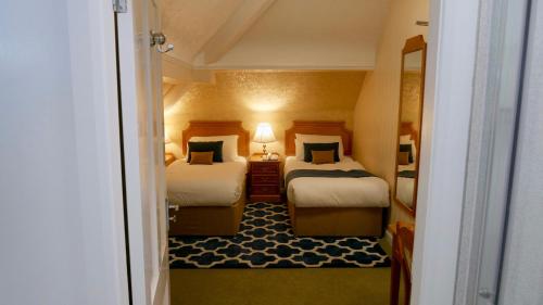 Llit o llits en una habitació de Trivelles Belforte Hotel