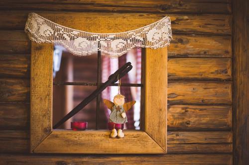 a small figurine in a window with a sword at Gazdovský dvor B&B s Mini Wellness in Bešeňová