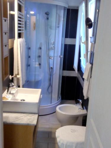 a bathroom with a shower and a toilet and a sink at Costa Morroni in Levanto