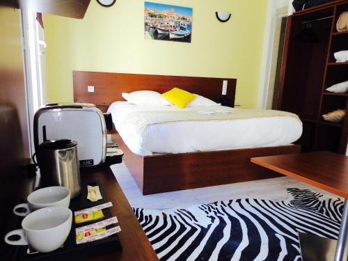a bedroom with a bed and a zebra print rug at Massilia hôtel in Marseille