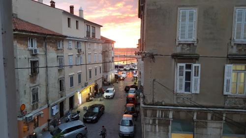 an overhead view of a city street with cars parked at Apartments San Rocco in Piran