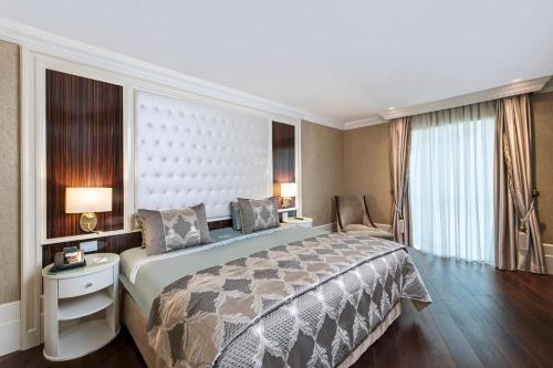 a hotel room with a large bed and a window at Elite World Istanbul Florya in Istanbul