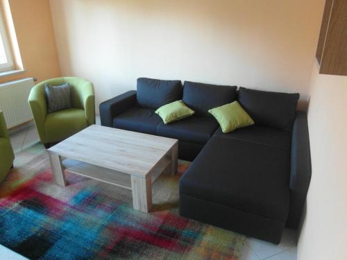 a living room with a couch and a coffee table at Pension Antik in Bad Lobenstein