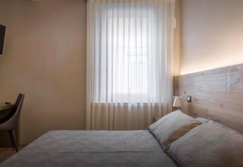 a bedroom with a large bed and a window at Accademia 21 in Mantova