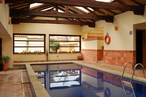 a large swimming pool in a house with a ceiling at Hotel y Spa Getsemani in Villa de Leyva