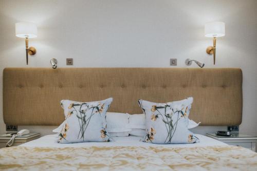 a bedroom with a bed with two pillows at Cragwood Country House Hotel in Windermere
