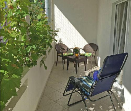 a patio with chairs and a table on a balcony at Apartments Bruno in Jurandvor